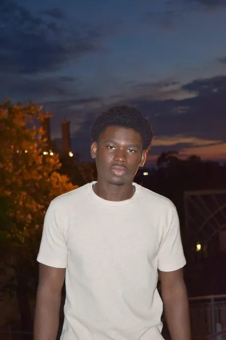 Joshua at dusk wearing a white shirt