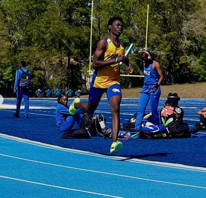 Joshua running on a blue track