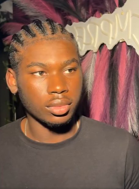 Joshua with fresh braids in warm indoor light