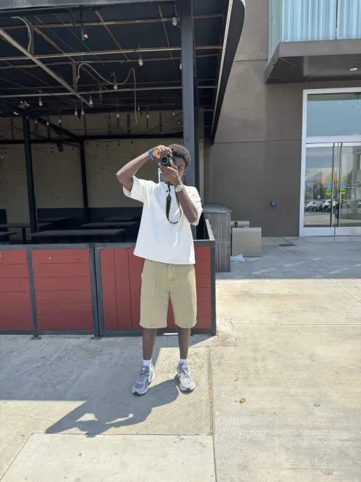 Joshua holding a camera outdoors