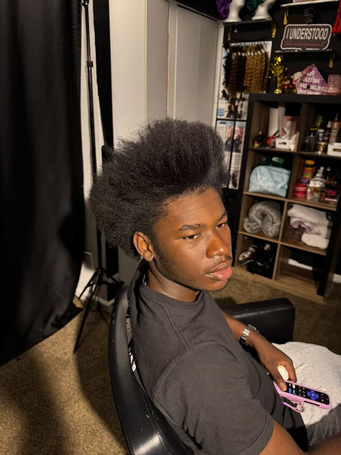 Side portrait of Joshua with a full hair blowout