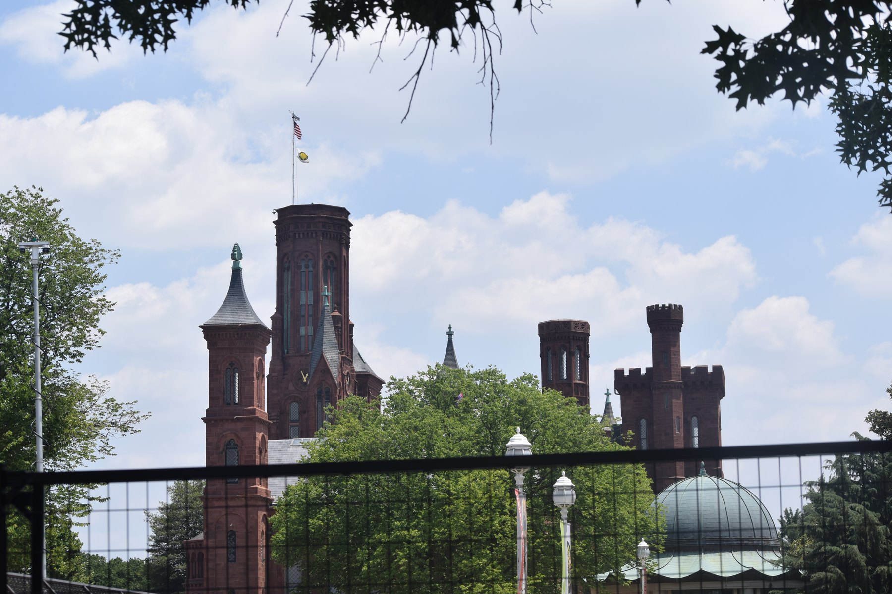 Smithsonian Castle towers framed by trees and sky